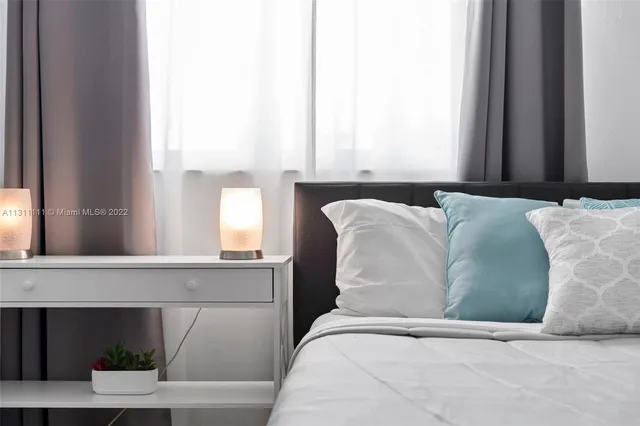 a bedroom with a bed and window