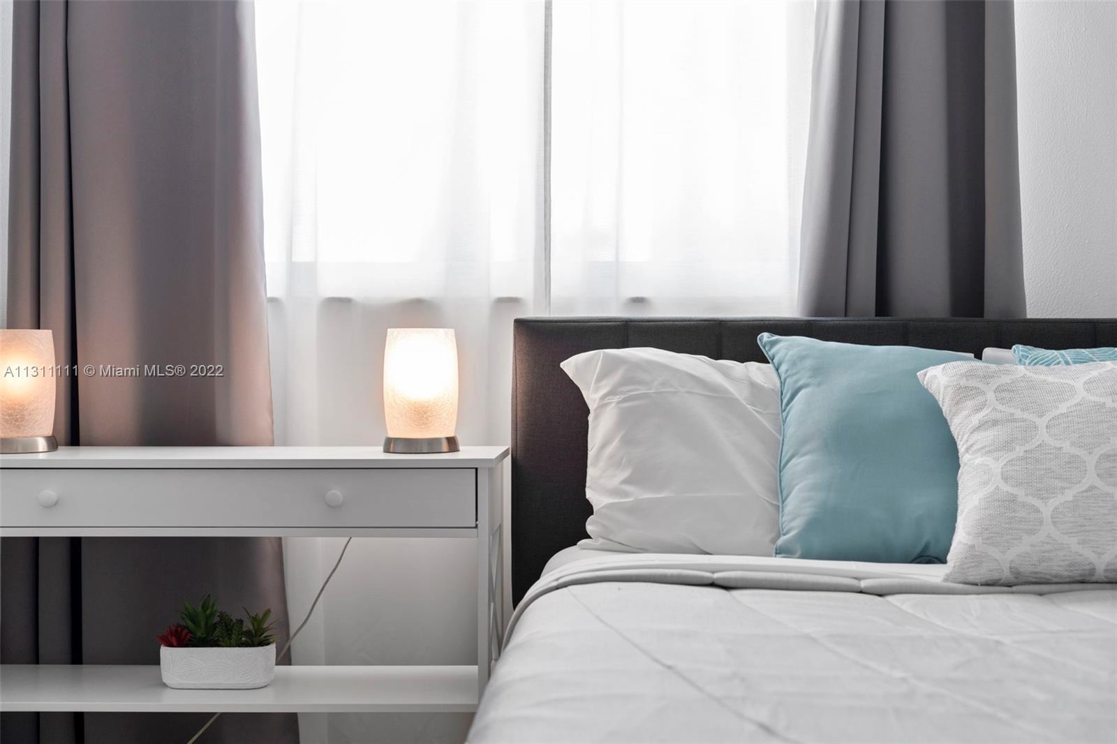 18100 North Bay Road, Unit 308 Sunny Isles Beach, FL 33160 - Photo 29 of 35 a bedroom with a bed and window