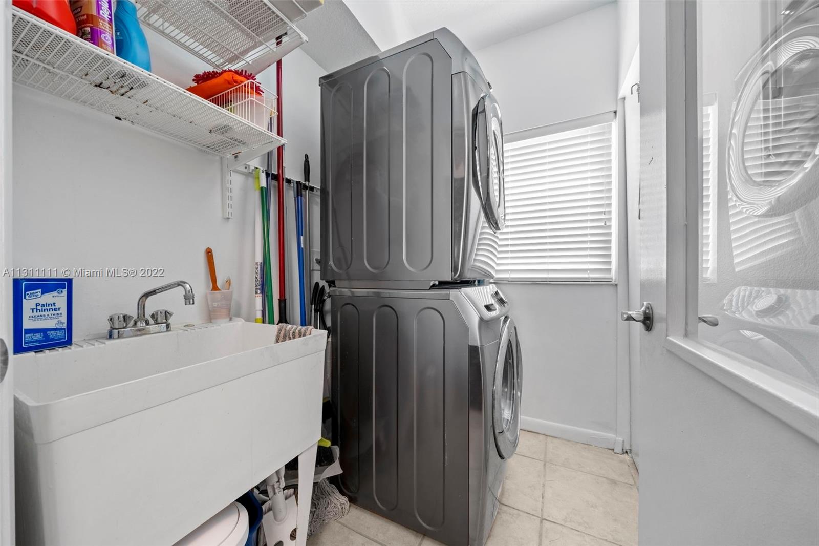 18100 North Bay Road, Unit 308 Sunny Isles Beach, FL 33160 - Photo 32 of 35 a utility room with dryer and washer