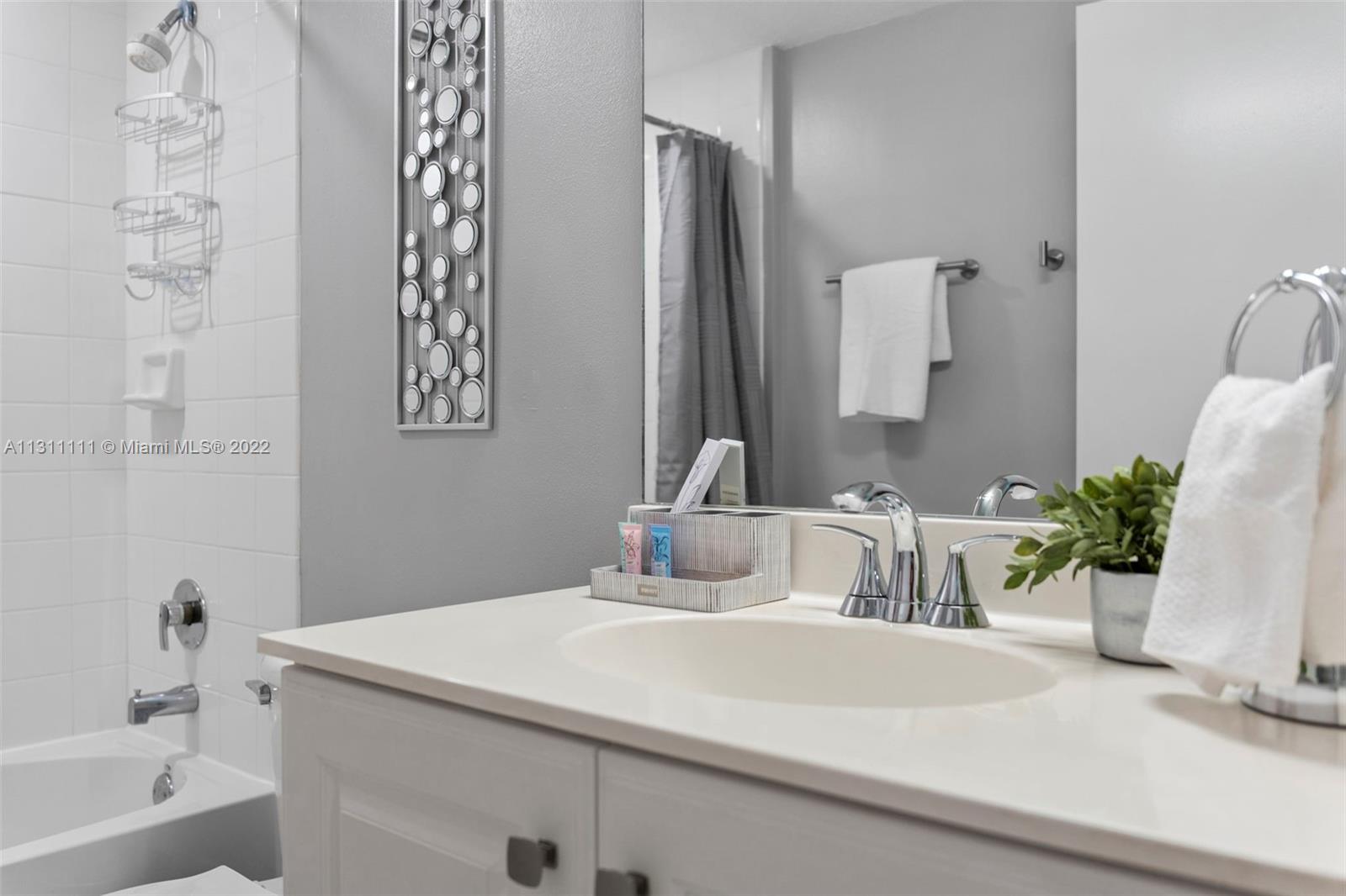 18100 North Bay Road, Unit 308 Sunny Isles Beach, FL 33160 - Photo 33 of 35 a bathroom with a sink and a mirror