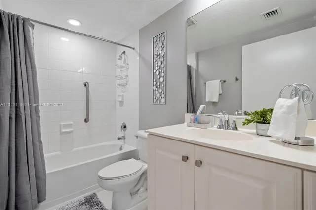 a bathroom with a sink toilet tub and shower
