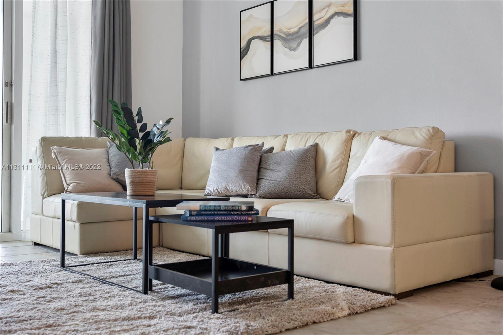 18100 North Bay Road, Unit 308 Sunny Isles Beach, FL 33160 - Photo 8 of 35 a living room with furniture