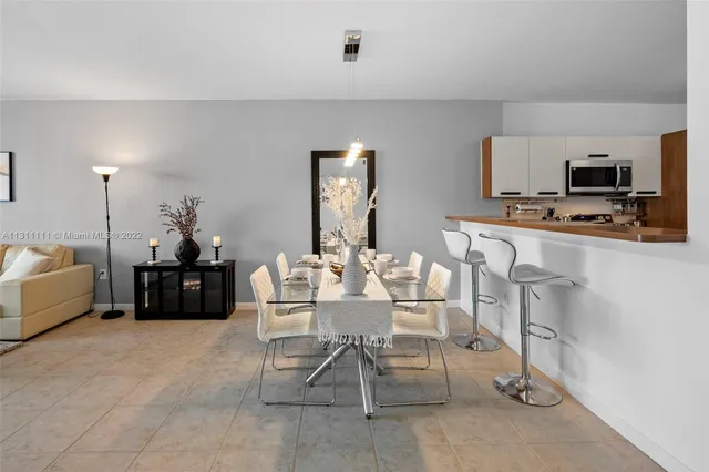 a living room with furniture a flat screen tv and a table