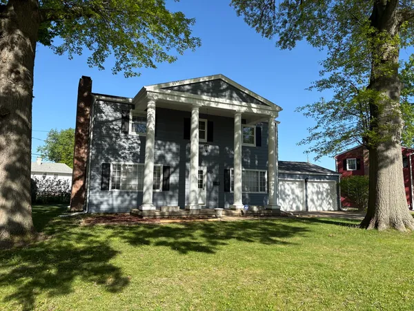 a view of a house with fountain bath tub and trees around