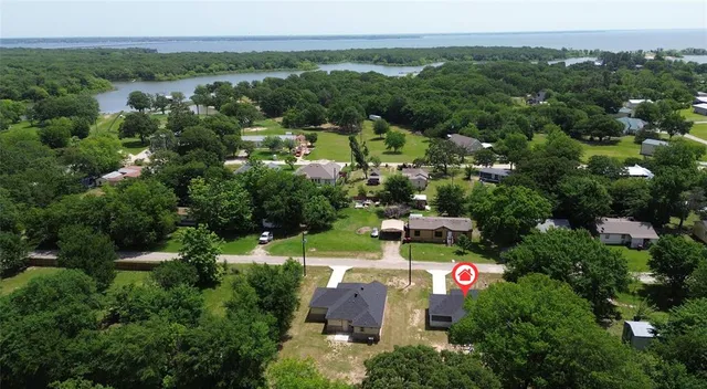 an aerial view of a city with lots of residential buildings and mountain view in back