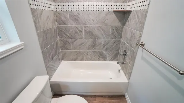 a bathroom with a bathtub and a shower