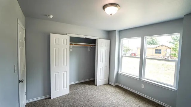 an empty room with closet area