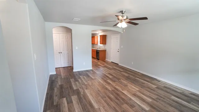 wooden floor in an empty room with a window