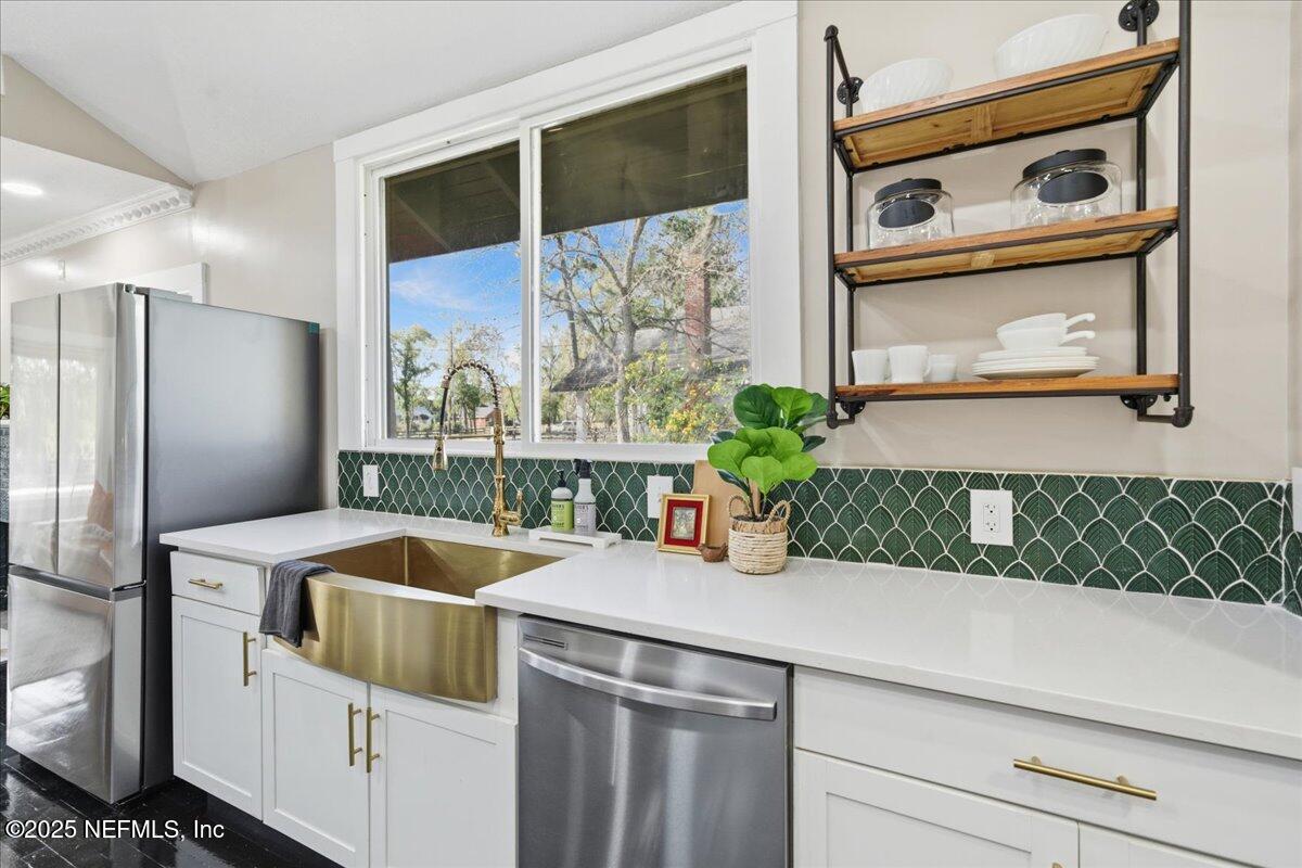 9671 Old Plank Road Jacksonville, FL 32220 - Photo 18 of 62 a kitchen with a sink and refrigerator