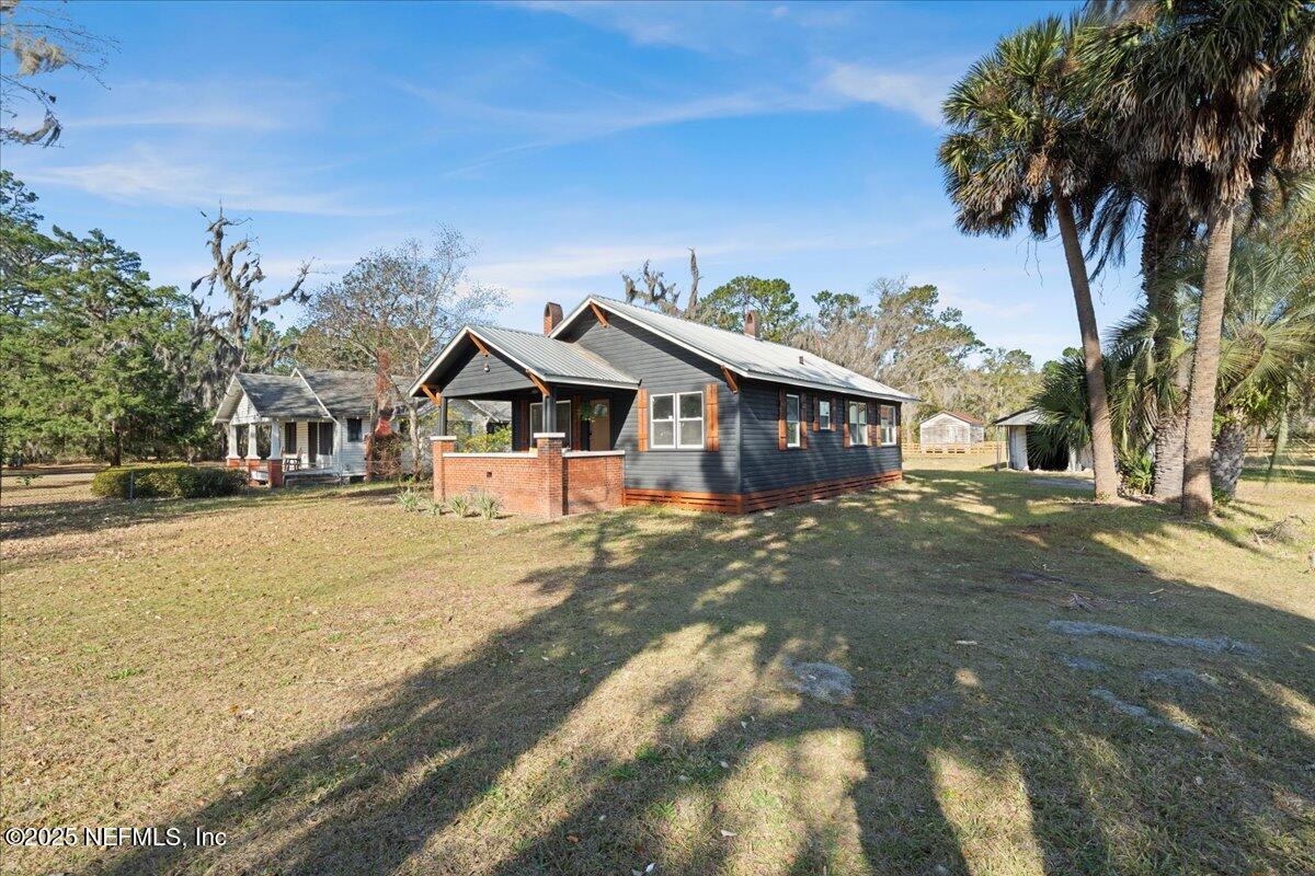 9671 Old Plank Road Jacksonville, FL 32220 - Photo 2 of 62 a front view of a house with a garden