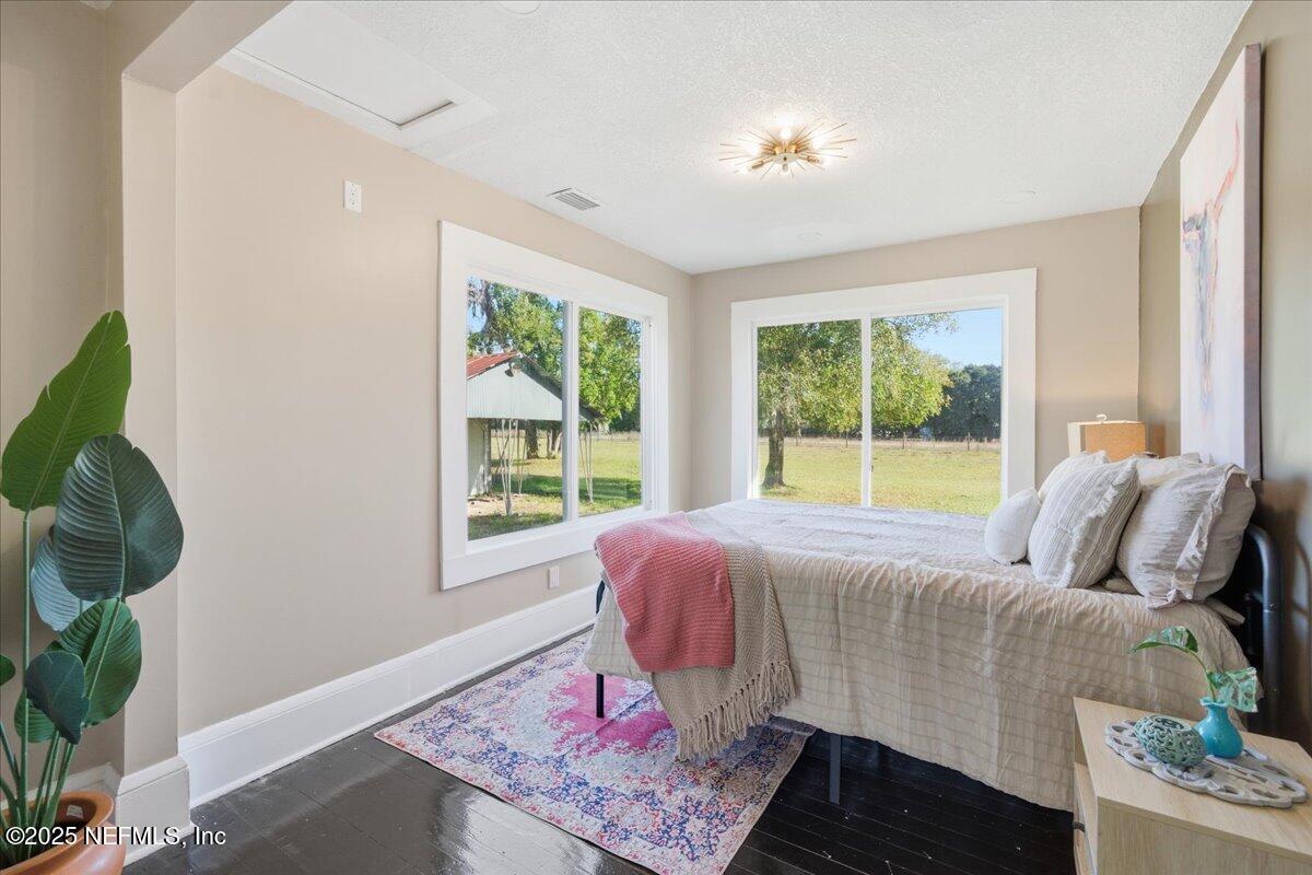 9671 Old Plank Road Jacksonville, FL 32220 - Photo 21 of 62 a bed sitting in a bedroom next to a window
