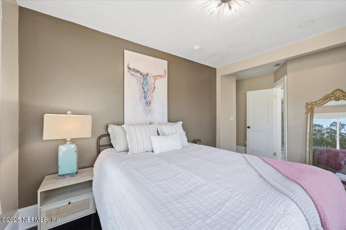 9671 Old Plank Road Jacksonville, FL 32220 - Photo 22 of 62 a bedroom with a bed and a lamp