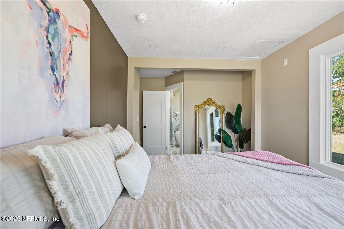 9671 Old Plank Road Jacksonville, FL 32220 - Photo 23 of 62 a bedroom with a bed and a mirror
