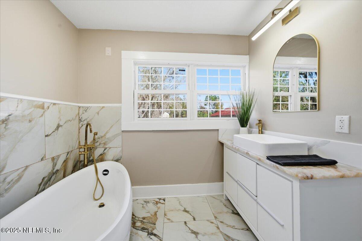 9671 Old Plank Road Jacksonville, FL 32220 - Photo 26 of 62 a bathroom with a granite countertop sink and a bathtub