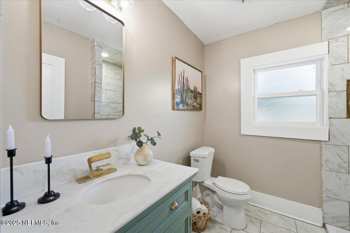 9671 Old Plank Road Jacksonville, FL 32220 - Photo 27 of 62 a bathroom with a sink vanity mirror and toilet