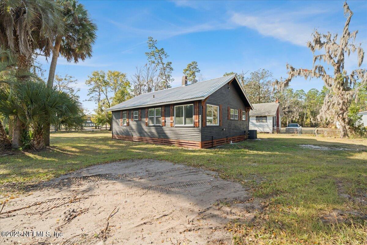 9671 Old Plank Road Jacksonville, FL 32220 - Photo 36 of 62 a view of a house with a yard