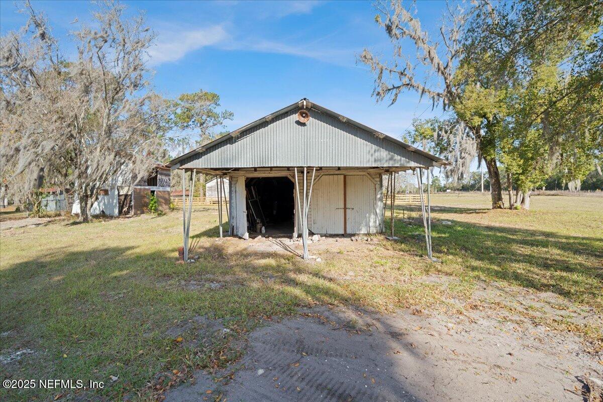 9671 Old Plank Road Jacksonville, FL 32220 - Photo 37 of 62 a view of a house with a yard and tree