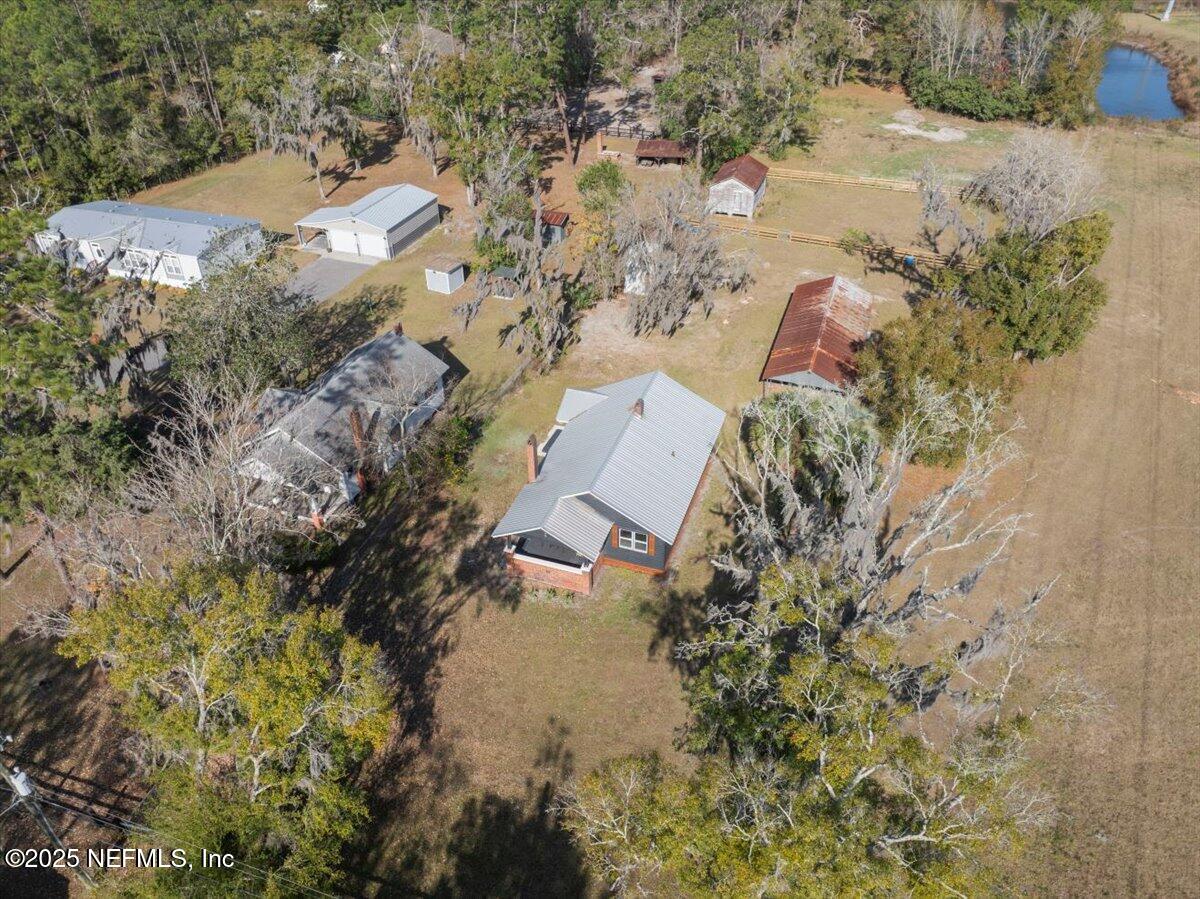 9671 Old Plank Road Jacksonville, FL 32220 - Photo 46 of 62 a aerial view of a house with a yard and lake view