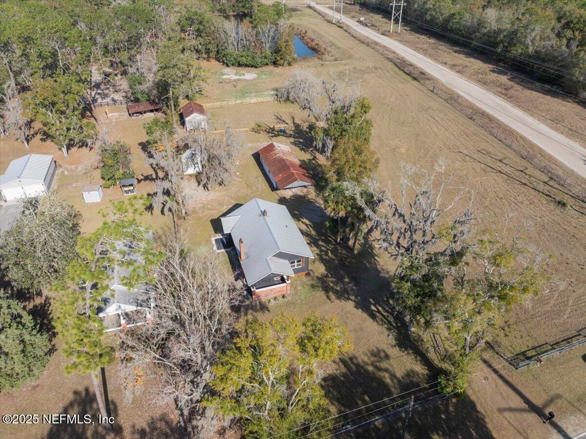 9671 Old Plank Road Jacksonville, FL 32220 - Photo 48 of 62 a aerial view of a house with a yard and garden
