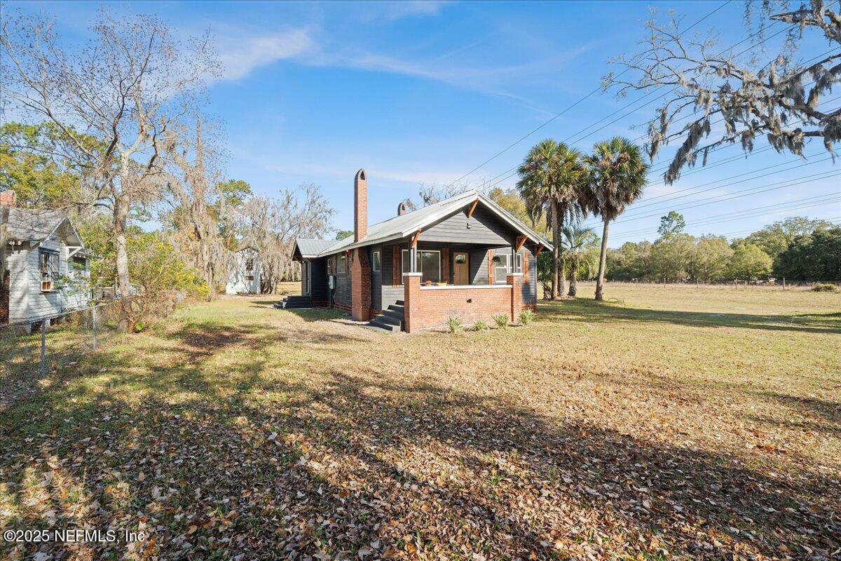9671 Old Plank Road Jacksonville, FL 32220 - Photo 5 of 62 a front view of a house with a yard and garage
