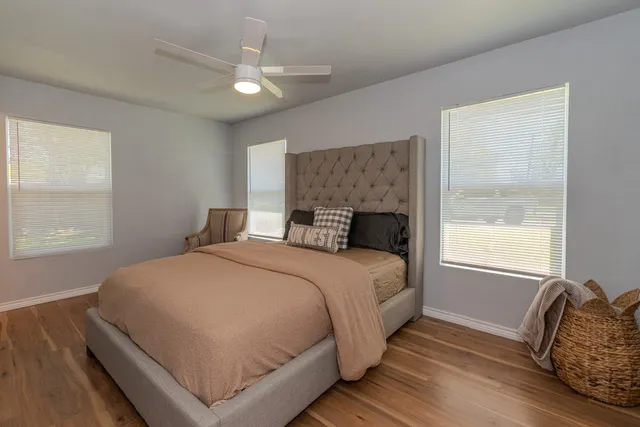 a bedroom with a large bed and a window