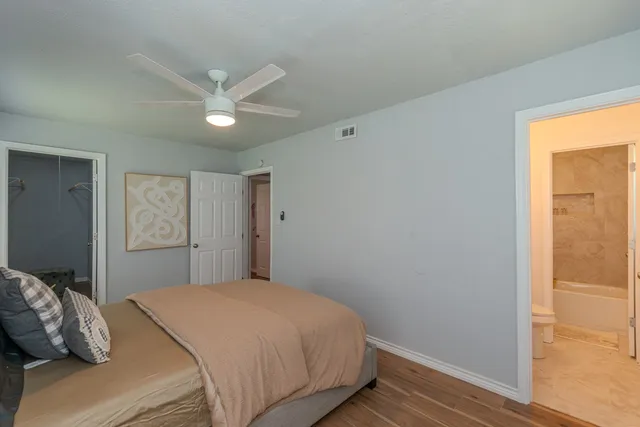 a bedroom with a large bed and a window