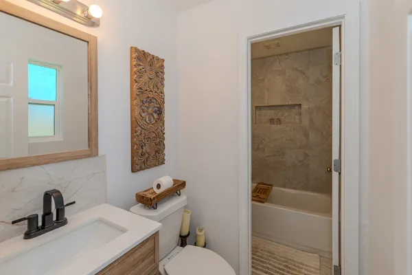 a bathroom with a sink toilet and shower