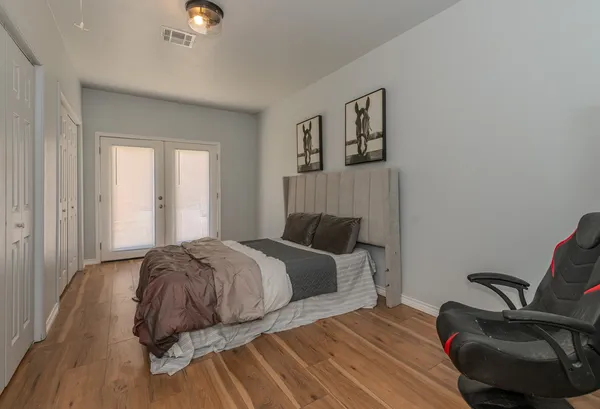 a bedroom with a bed and a chair