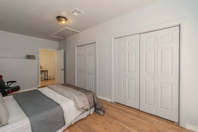 a bedroom with a bed and a closet