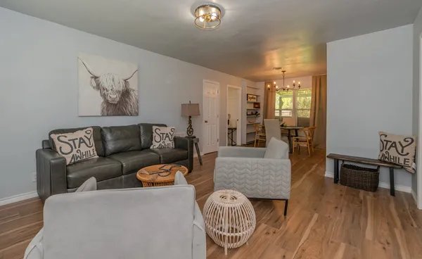 a living room with furniture and wooden floor