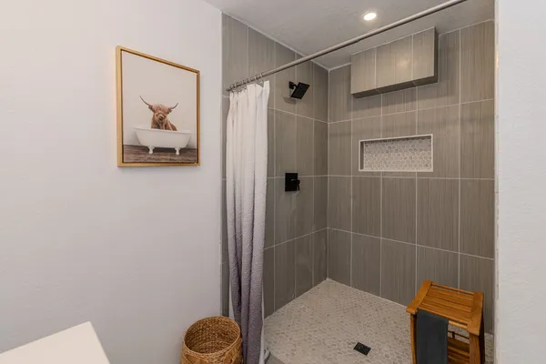 a bathroom with a shower and toilet