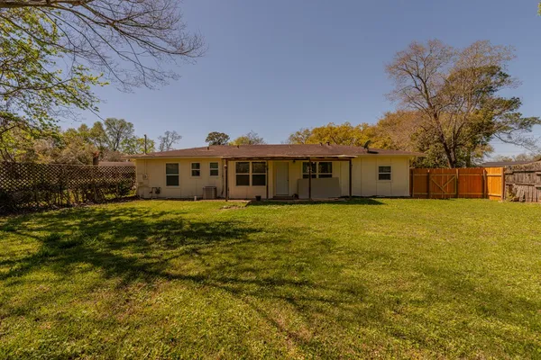 a front view of a house with a big yard