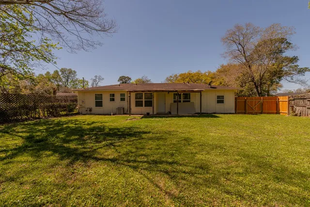 a front view of a house with a big yard