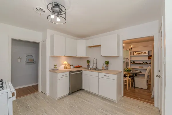 a kitchen with stainless steel appliances granite countertop a stove and cabinets