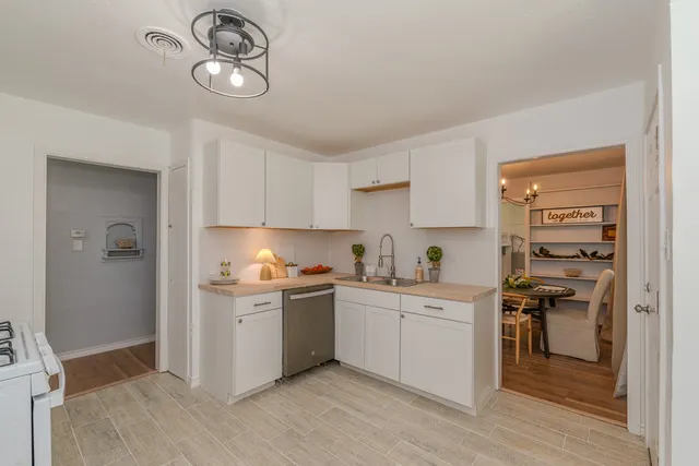 a kitchen with stainless steel appliances granite countertop a stove and cabinets