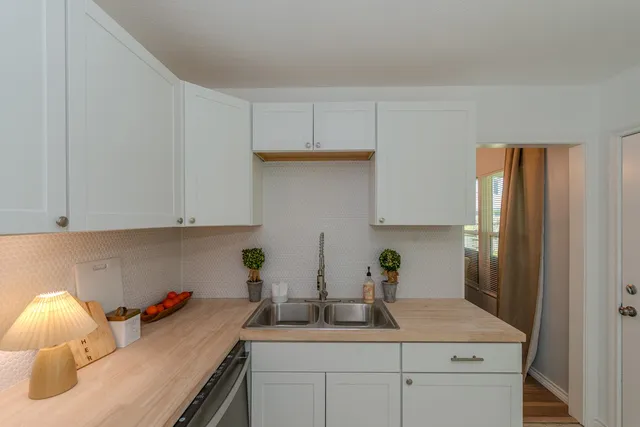 a kitchen with a sink and cabinets
