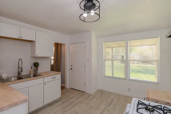 a kitchen with a sink cabinets and window