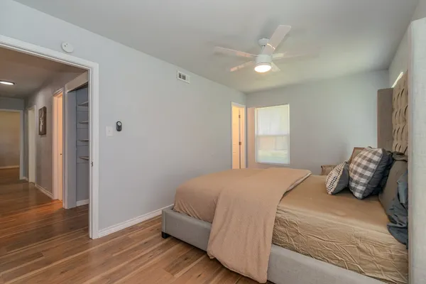 a bedroom with a large bed and a window