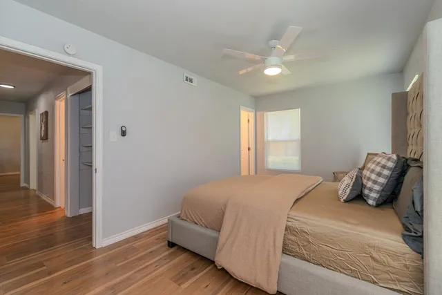 a bedroom with a large bed and a window