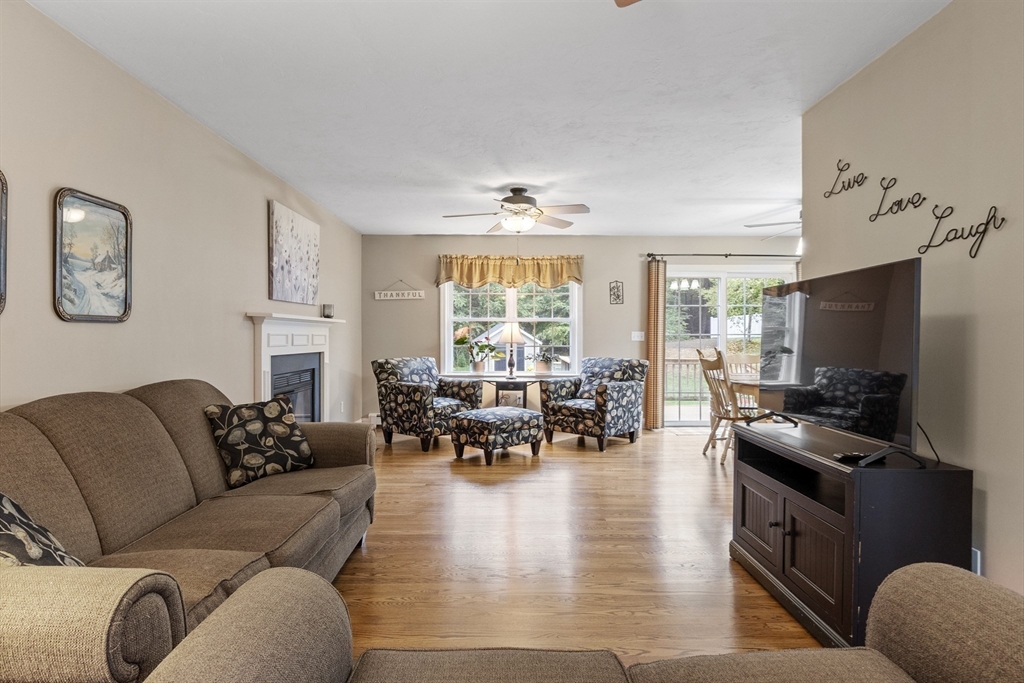 74 King Road Charlton, MA 01507 - Photo 12 of 38 a living room with furniture and a flat screen tv with kitchen view