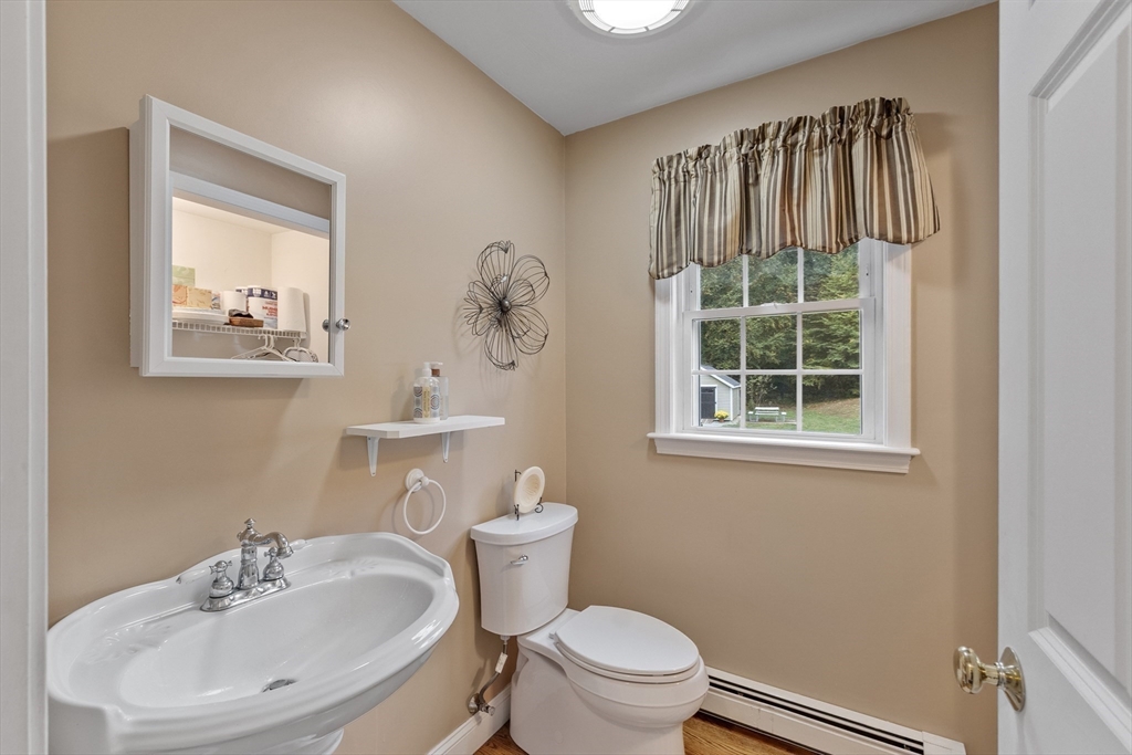 74 King Road Charlton, MA 01507 - Photo 15 of 38 a bathroom with a sink a toilet and a mirror
