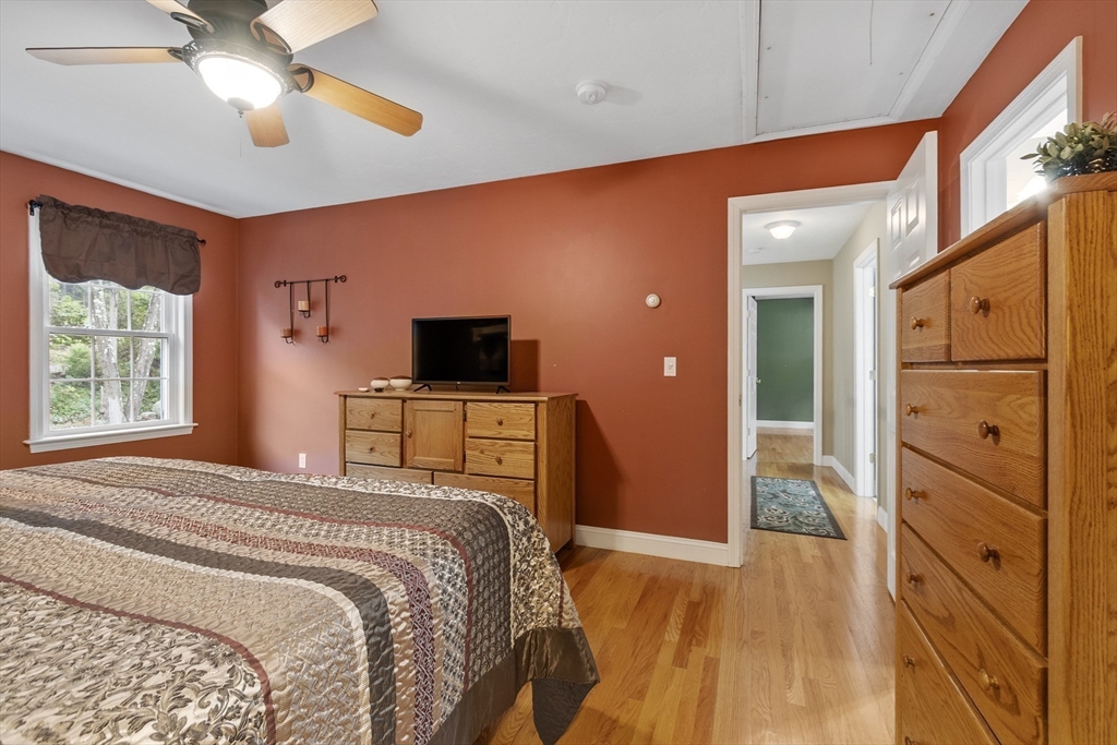 74 King Road Charlton, MA 01507 - Photo 19 of 38 a bedroom with a bed and a flat tv screen on dresser