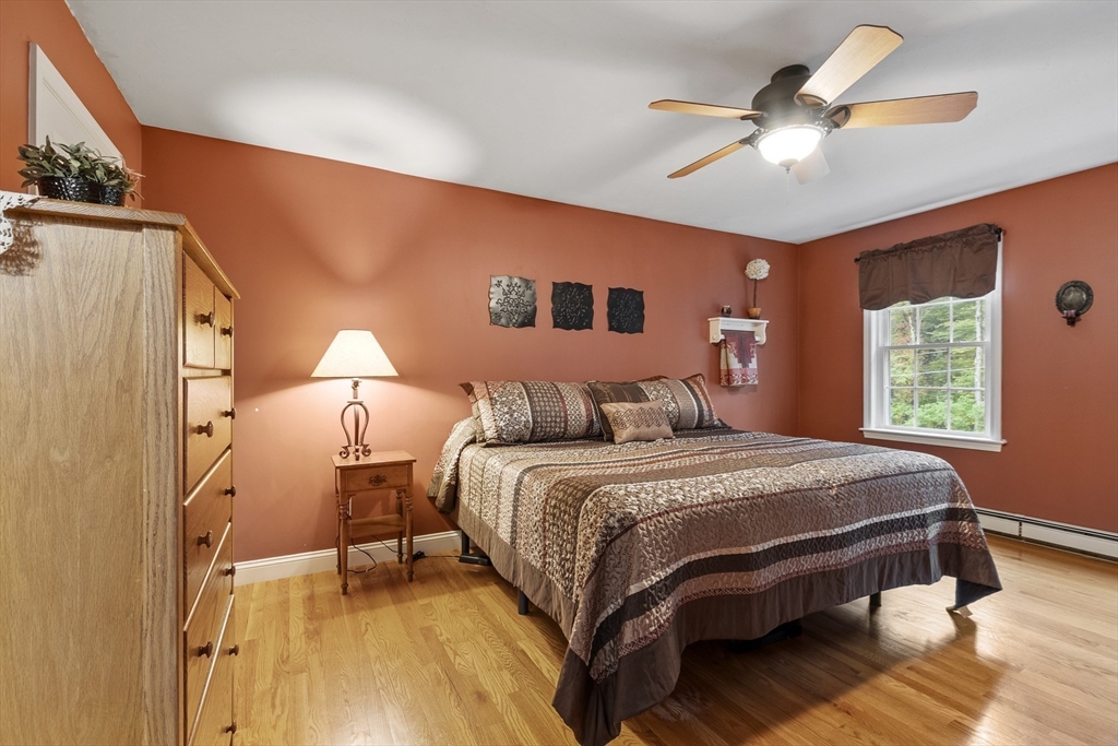 74 King Road Charlton, MA 01507 - Photo 21 of 38 a bedroom with a bed and a chandelier