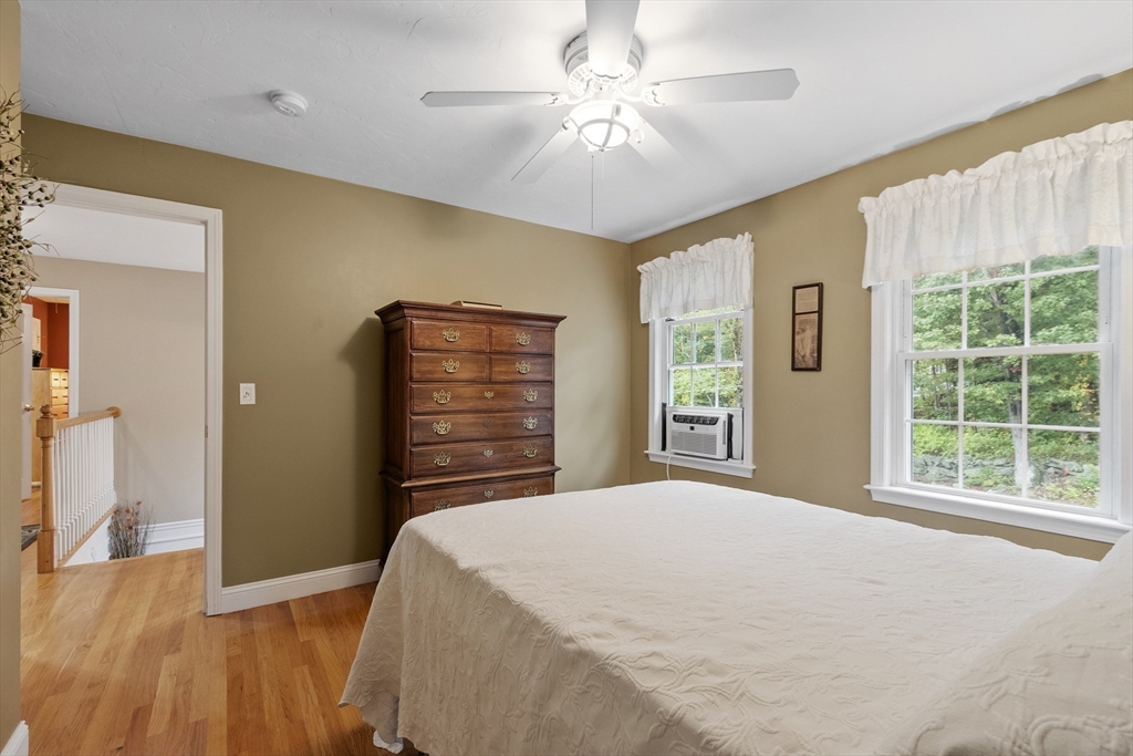 74 King Road Charlton, MA 01507 - Photo 26 of 38 a bedroom with a bed and a chandelier