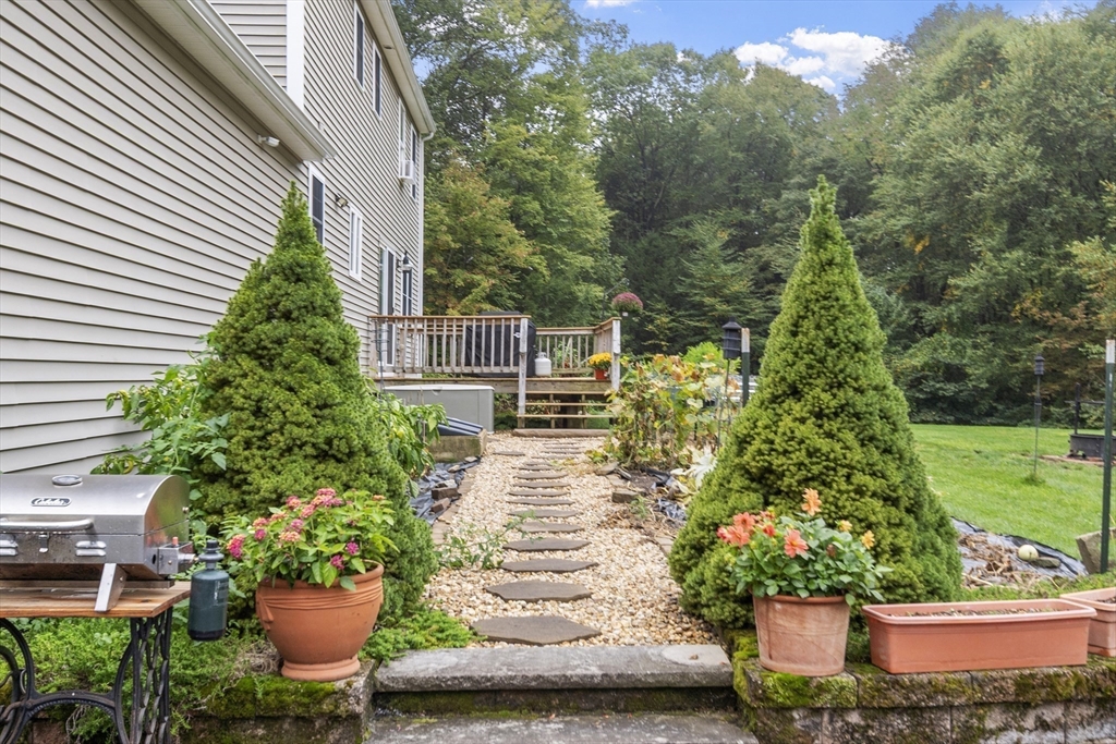 74 King Road Charlton, MA 01507 - Photo 32 of 38 a view of a house with a yard and potted plants