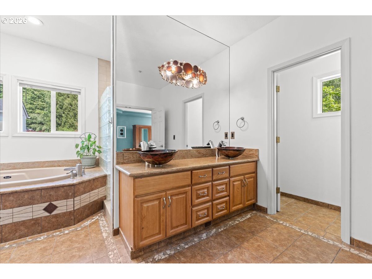 12431 Southwest 55th Place Portland, OR 97219 - Photo 16 of 40 a spacious bathroom with a sink double vanity and a mirror
