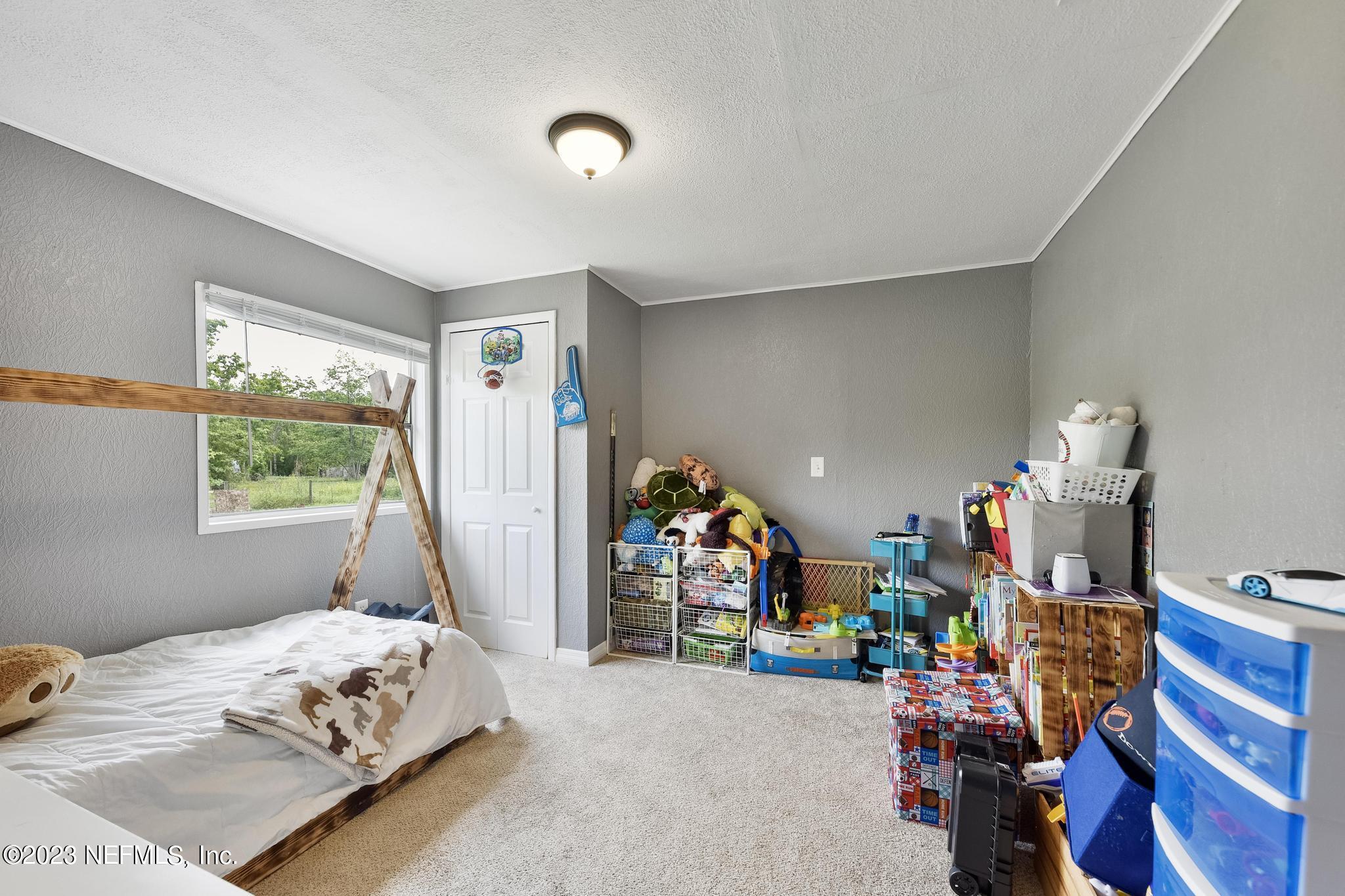 54042 Vikki Road Callahan, FL 32011 - Photo 21 of 31 a bedroom with bed and a window