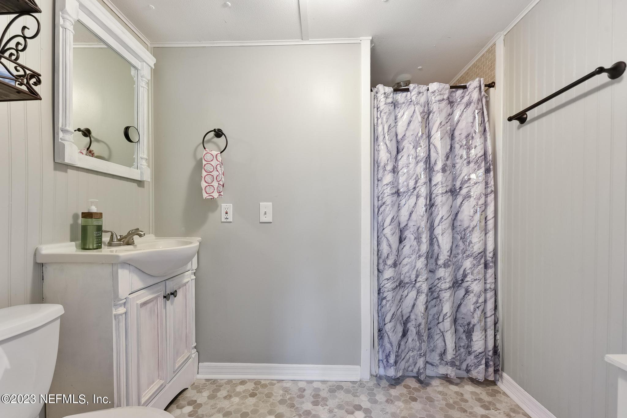54042 Vikki Road Callahan, FL 32011 - Photo 25 of 31 a bathroom with a sink toilet and shower