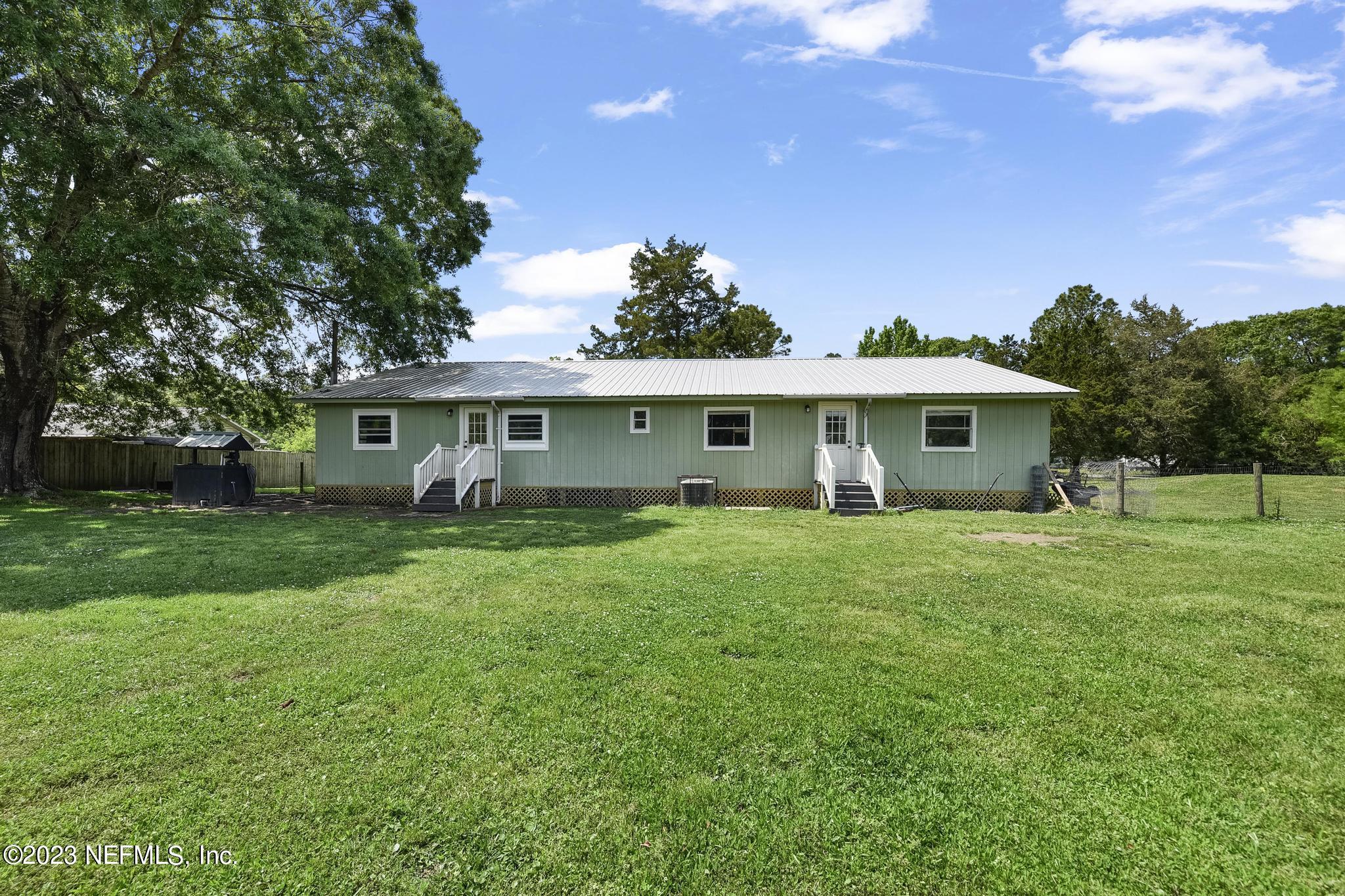 54042 Vikki Road Callahan, FL 32011 - Photo 29 of 31 a front view of a house with a garden