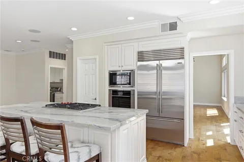 a kitchen with granite countertop a refrigerator and a stove